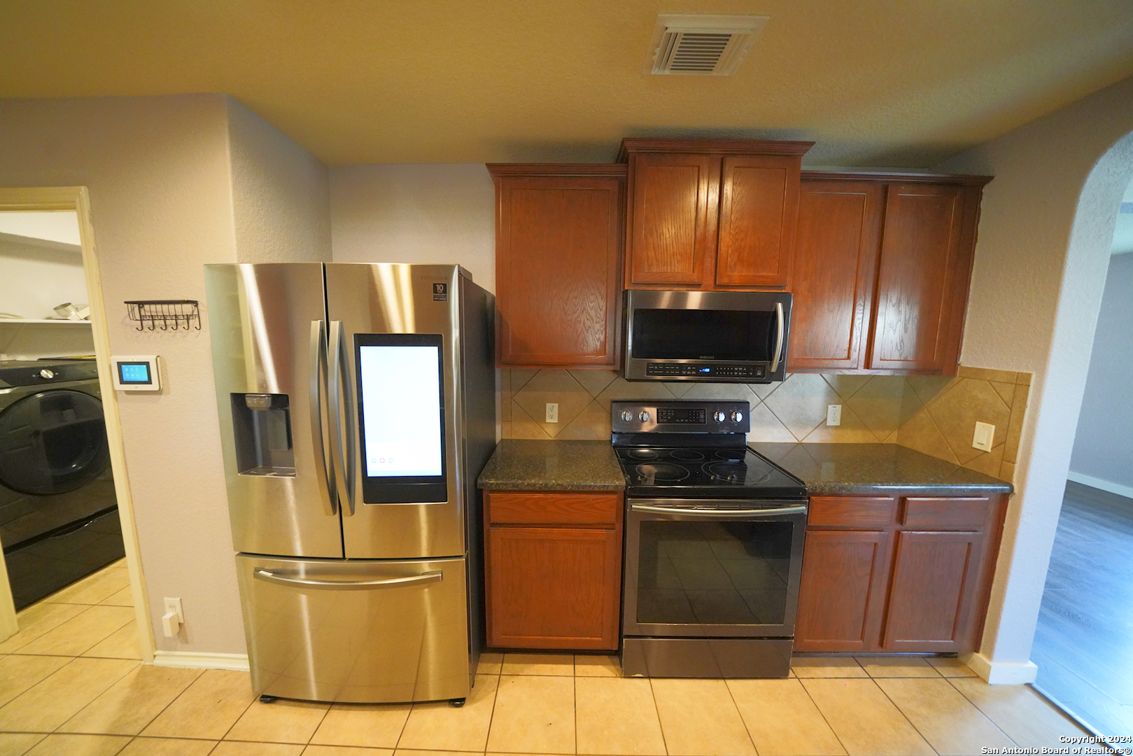 523 Diana Drive Converse, TX 78109 - Photo 17 of 50 a kitchen with stainless steel appliances granite countertop a refrigerator stove and microwave