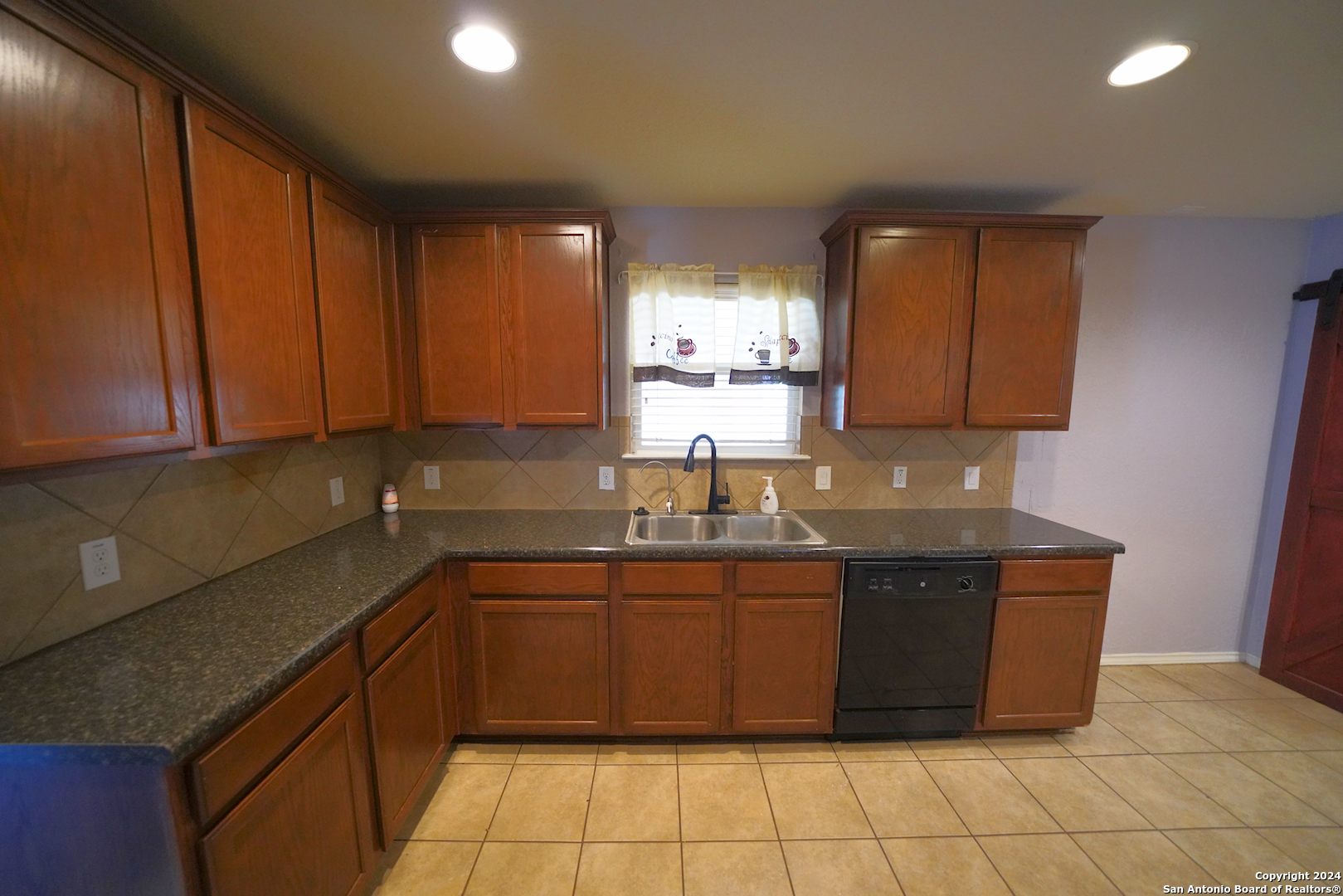 523 Diana Drive Converse, TX 78109 - Photo 18 of 50 a kitchen with a sink a stove top oven and cabinets