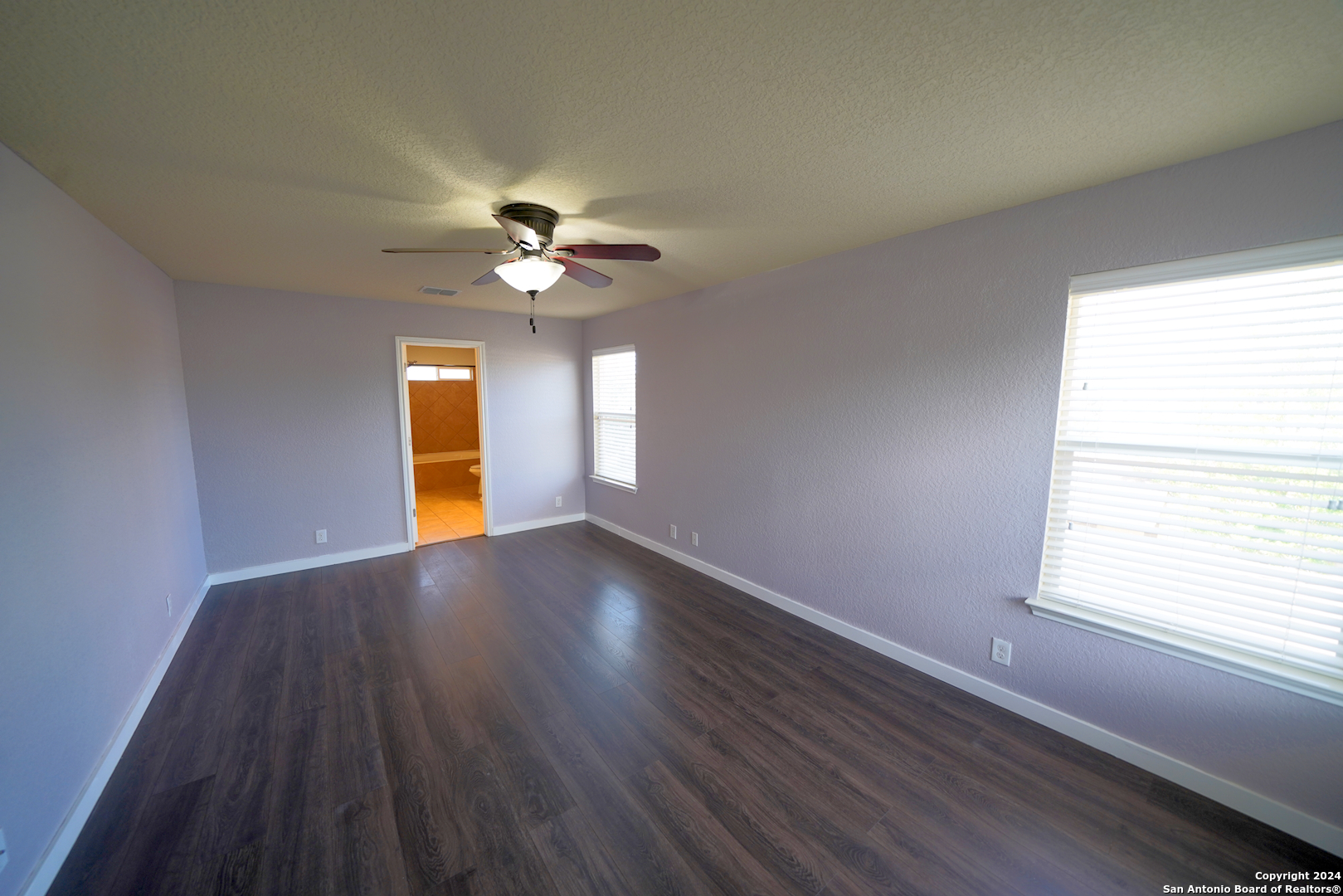 523 Diana Drive Converse, TX 78109 - Photo 21 of 50 a view of an empty room with a window and wooden floor
