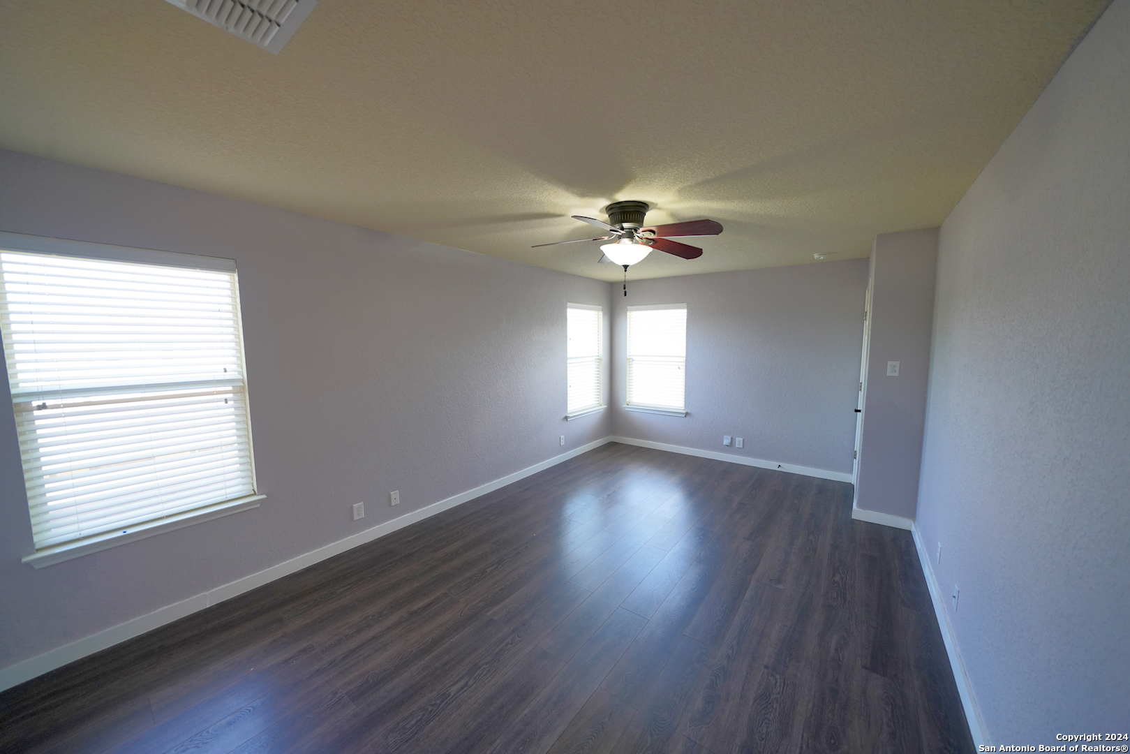 523 Diana Drive Converse, TX 78109 - Photo 22 of 50 a view of an empty room with wooden floor and a window