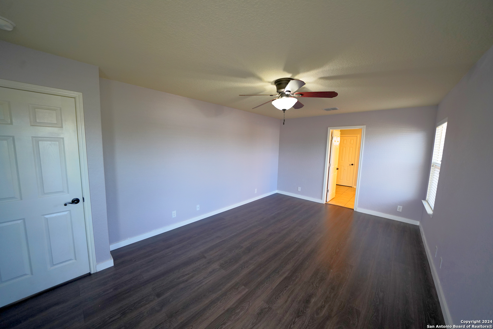 523 Diana Drive Converse, TX 78109 - Photo 24 of 50 a view of an empty room with a window and wooden floor