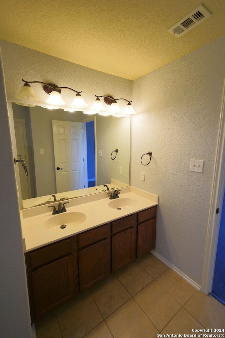 523 Diana Drive Converse, TX 78109 - Photo 25 of 50 a bathroom with a double vanity sink and mirror