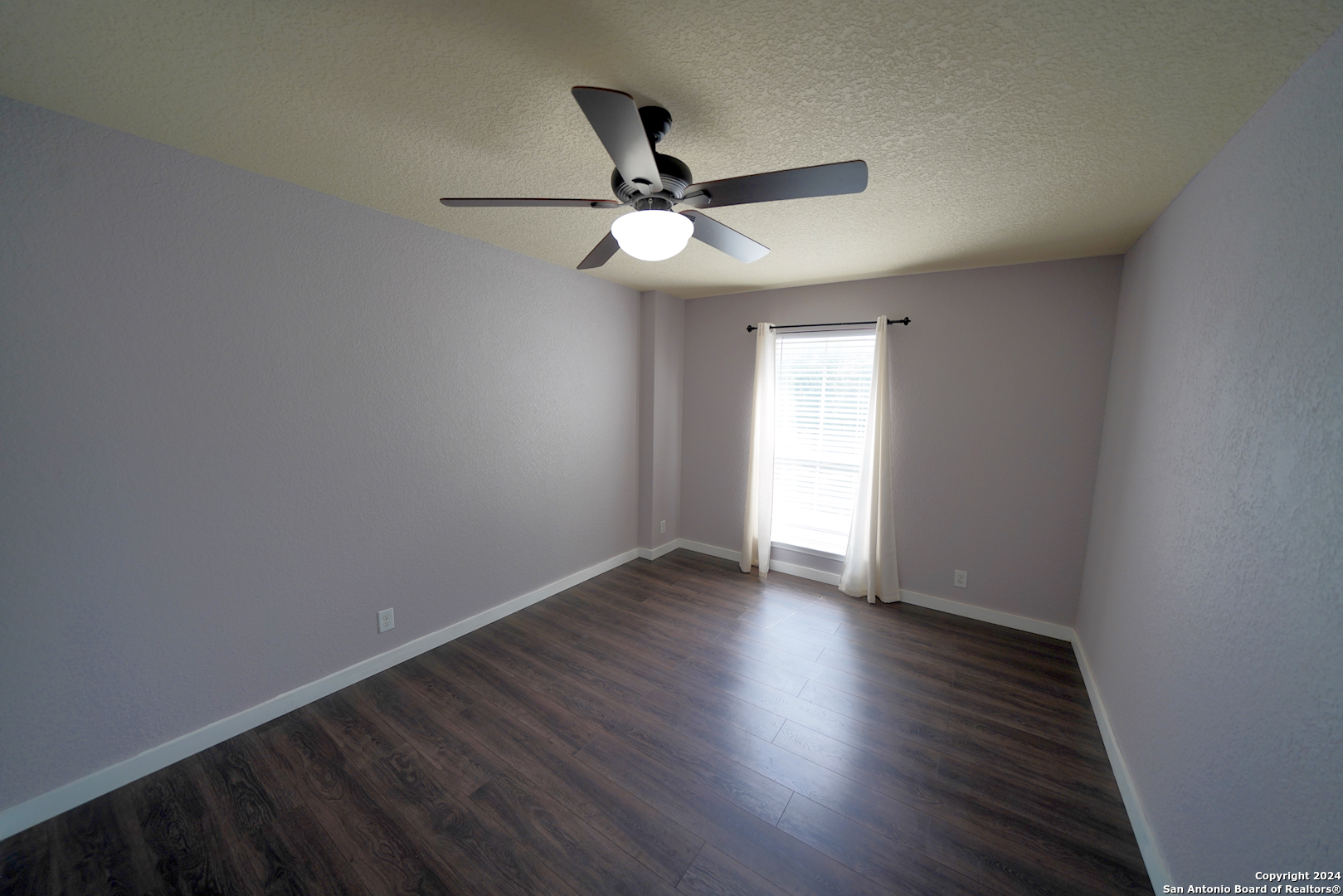 523 Diana Drive Converse, TX 78109 - Photo 29 of 50 a view of an empty room with wooden floor and a window