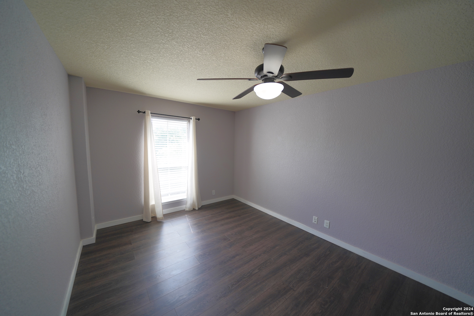 523 Diana Drive Converse, TX 78109 - Photo 30 of 50 an empty room with wooden floor and windows