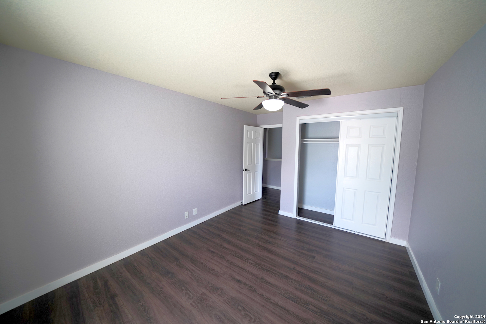 523 Diana Drive Converse, TX 78109 - Photo 31 of 50 a view of a room with wooden floor and a ceiling fan