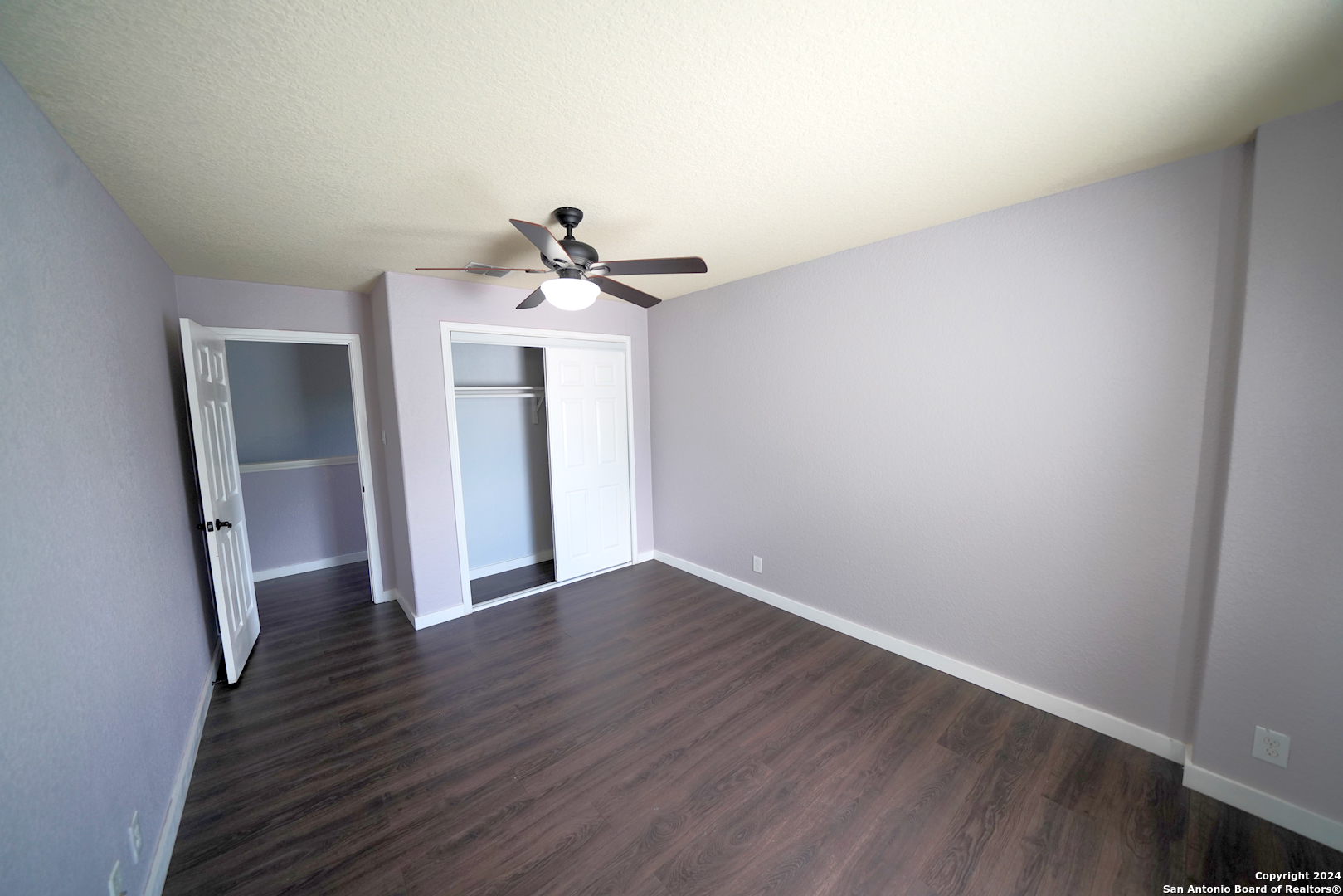 523 Diana Drive Converse, TX 78109 - Photo 32 of 50 a view of a hallway with wooden floor and a ceiling fan