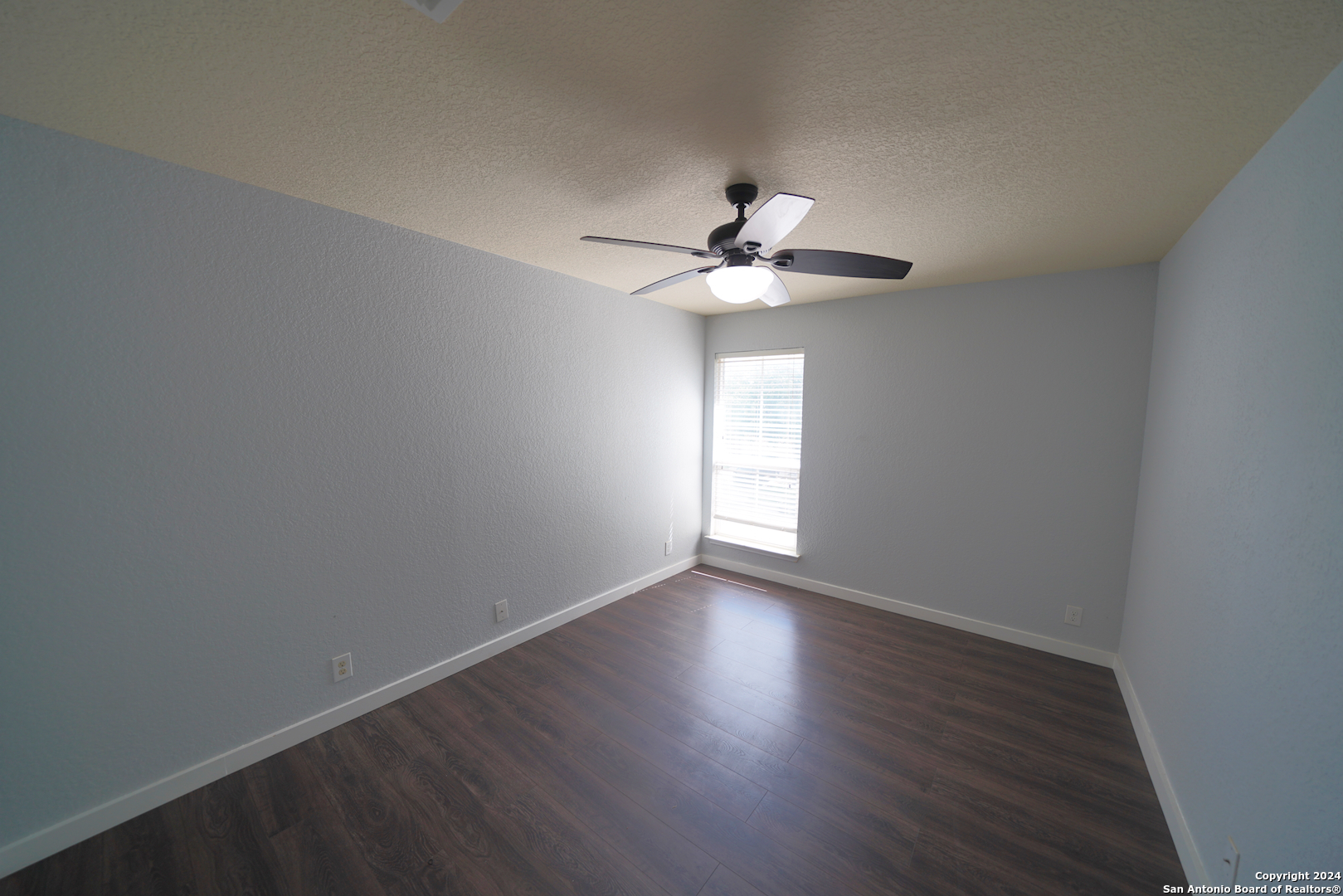 523 Diana Drive Converse, TX 78109 - Photo 33 of 50 a view of an empty room with a window and wooden floor