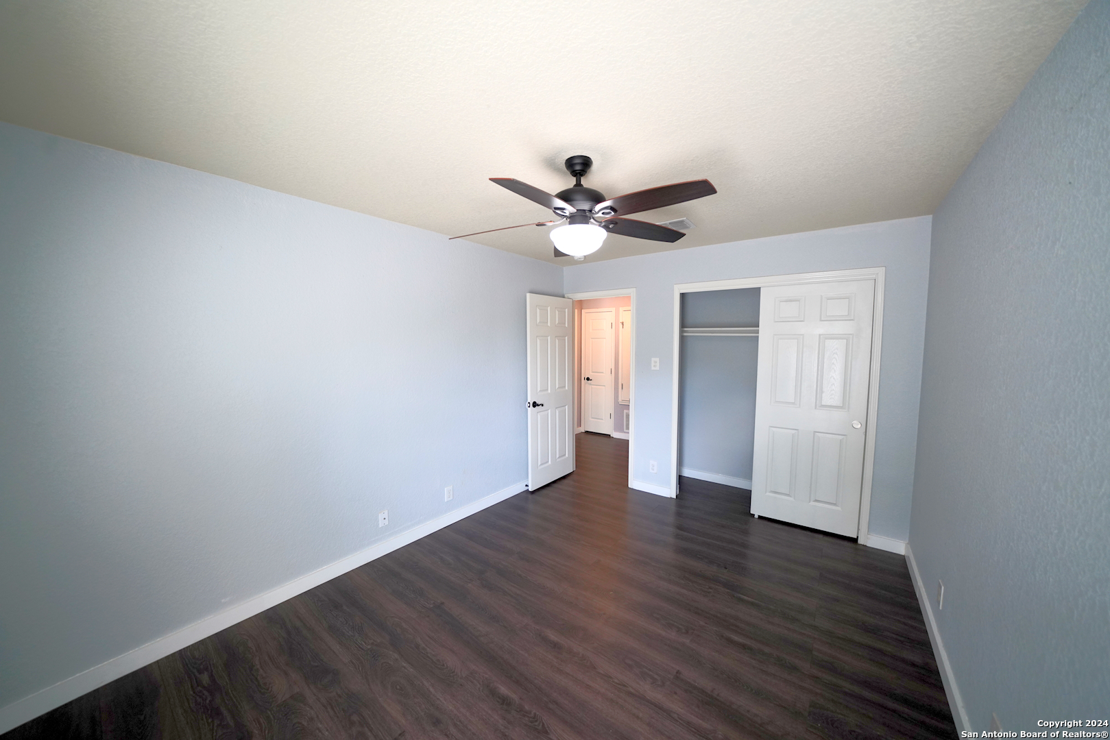 523 Diana Drive Converse, TX 78109 - Photo 35 of 50 an empty room with wooden floor and ceiling fan