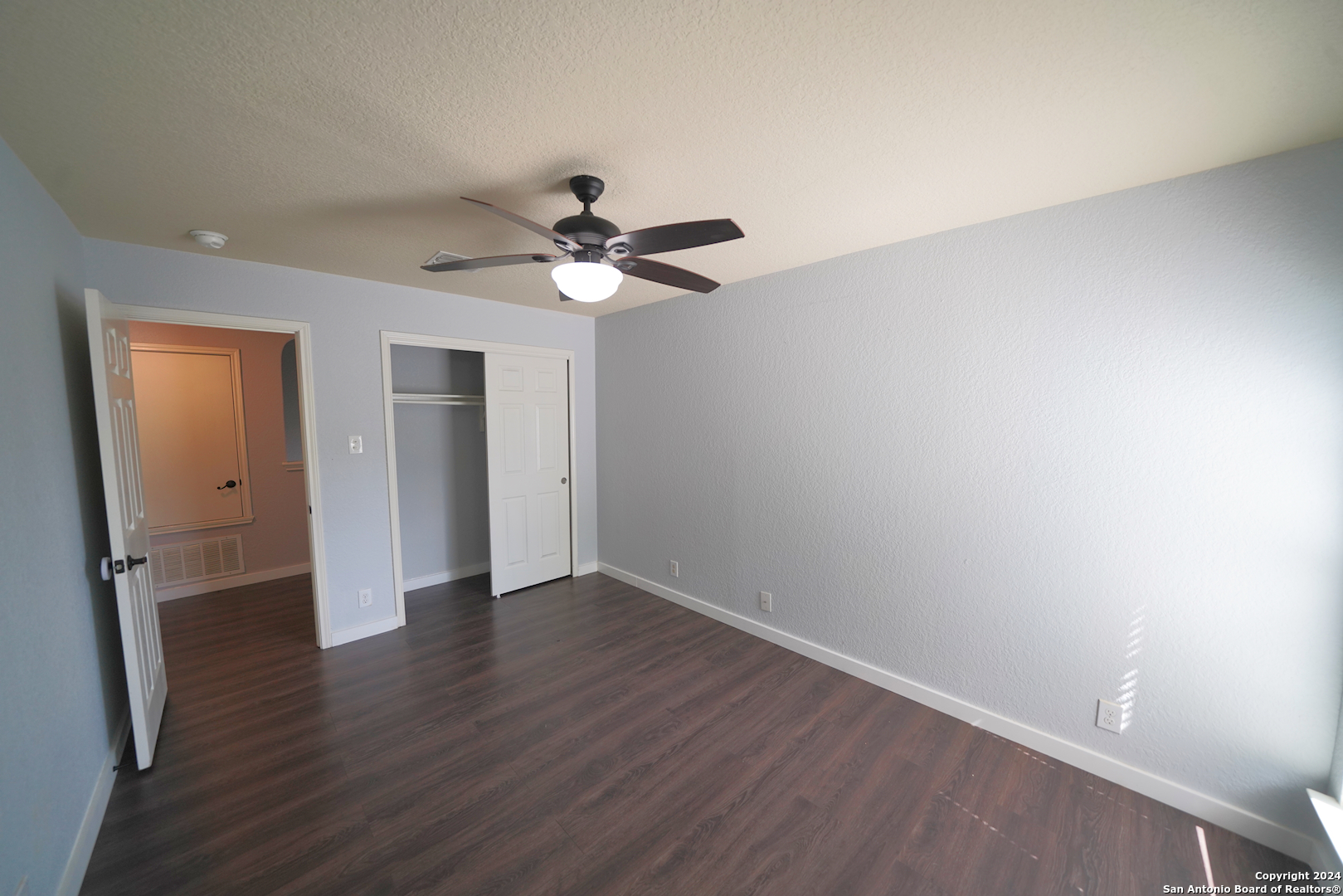 523 Diana Drive Converse, TX 78109 - Photo 36 of 50 an empty room with wooden floor and ceiling fan