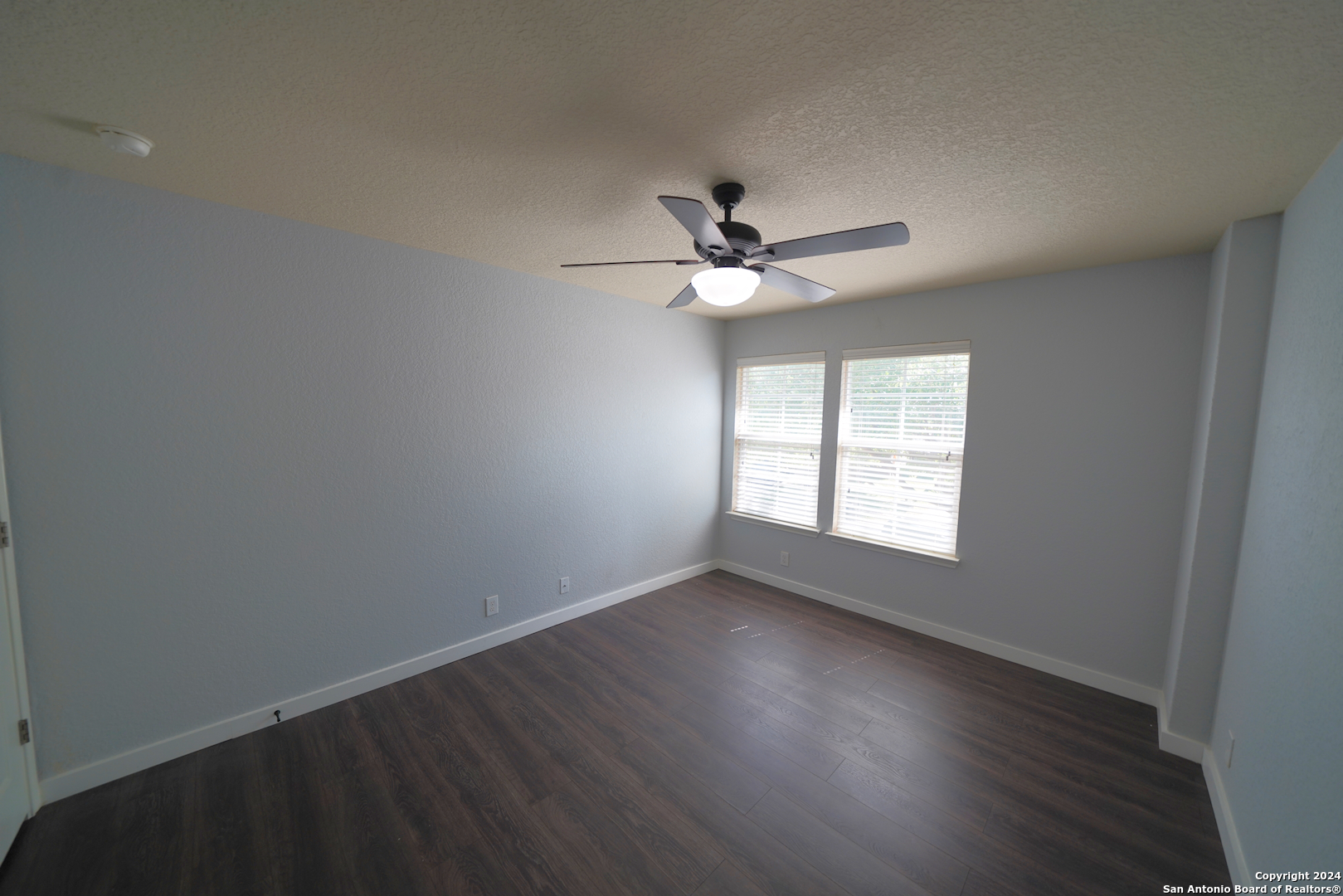 523 Diana Drive Converse, TX 78109 - Photo 38 of 50 an empty room with wooden floor and windows