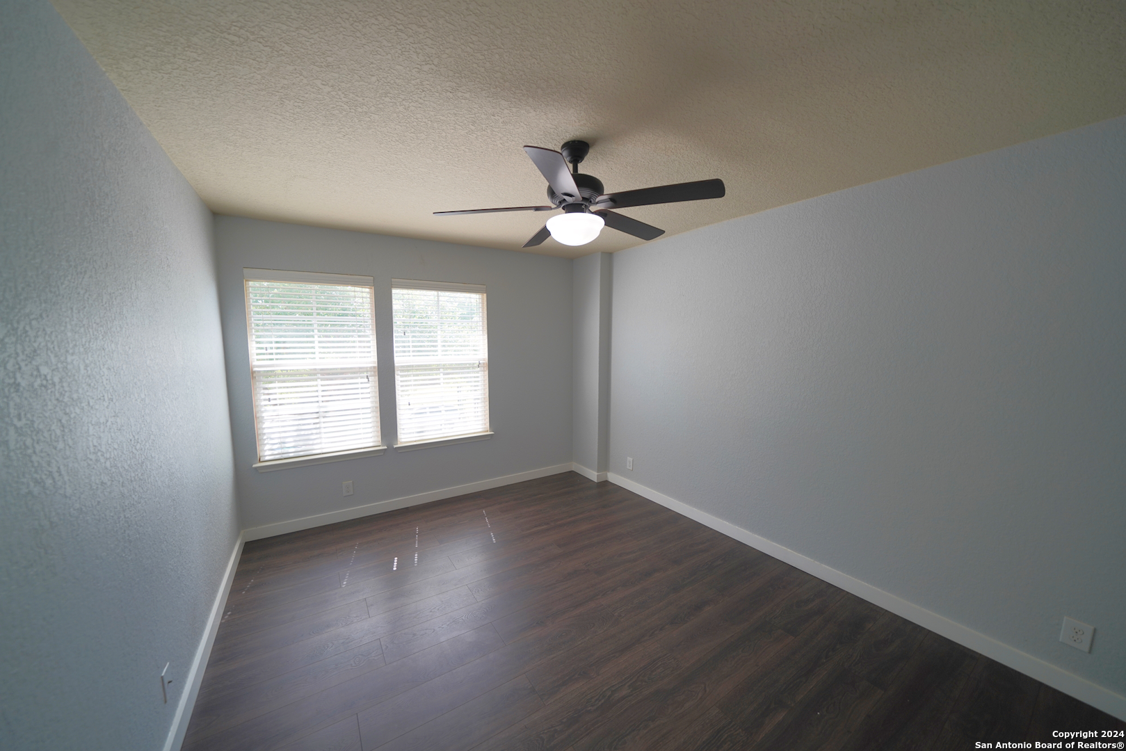 523 Diana Drive Converse, TX 78109 - Photo 39 of 50 an empty room with wooden floor and windows