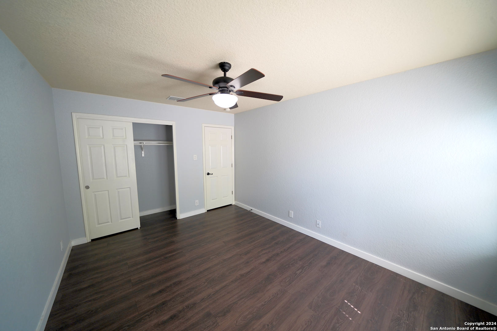 523 Diana Drive Converse, TX 78109 - Photo 41 of 50 a view of a room with wooden floor and a ceiling fan