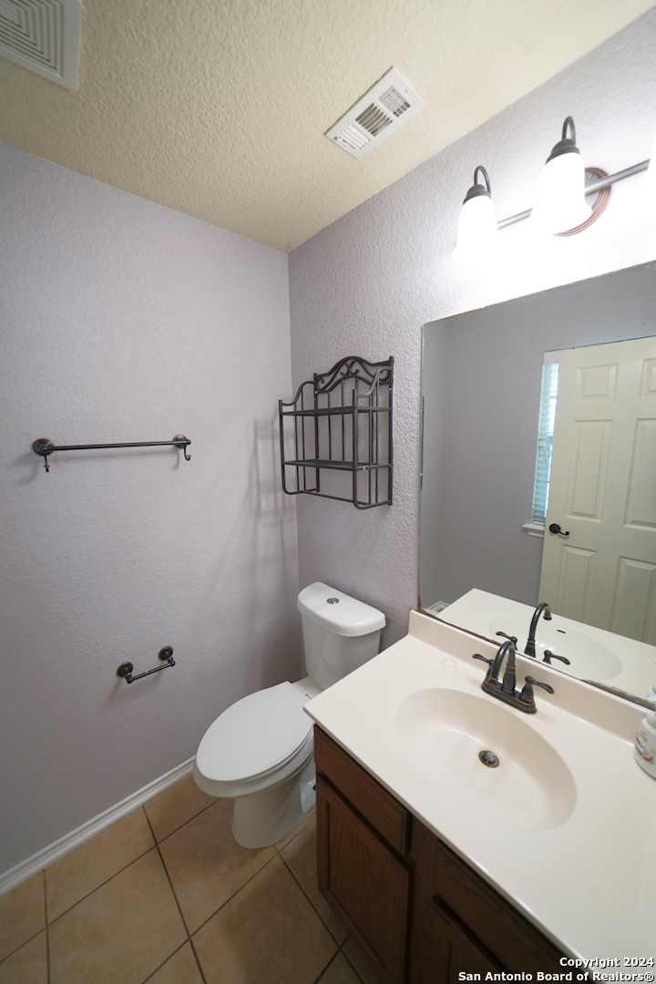 523 Diana Drive Converse, TX 78109 - Photo 42 of 50 a bathroom with a toilet a sink and mirror