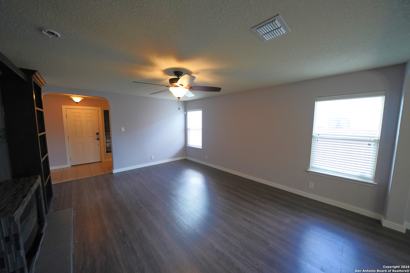 523 Diana Drive Converse, TX 78109 - Photo 10 of 50 an empty room with wooden floor and windows