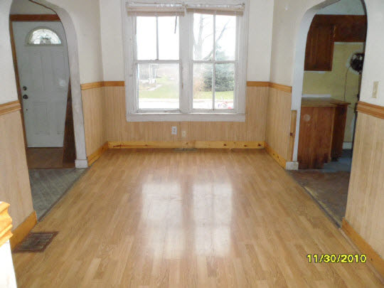12 Garfield Road Harvard, IL 60033 - Photo 4 of 11 an empty room with wooden floor and windows