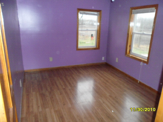 12 Garfield Road Harvard, IL 60033 - Photo 5 of 11 a view of an empty room with wooden floor and a window