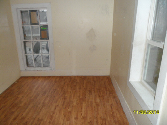12 Garfield Road Harvard, IL 60033 - Photo 8 of 11 an empty room with wooden floor and windows