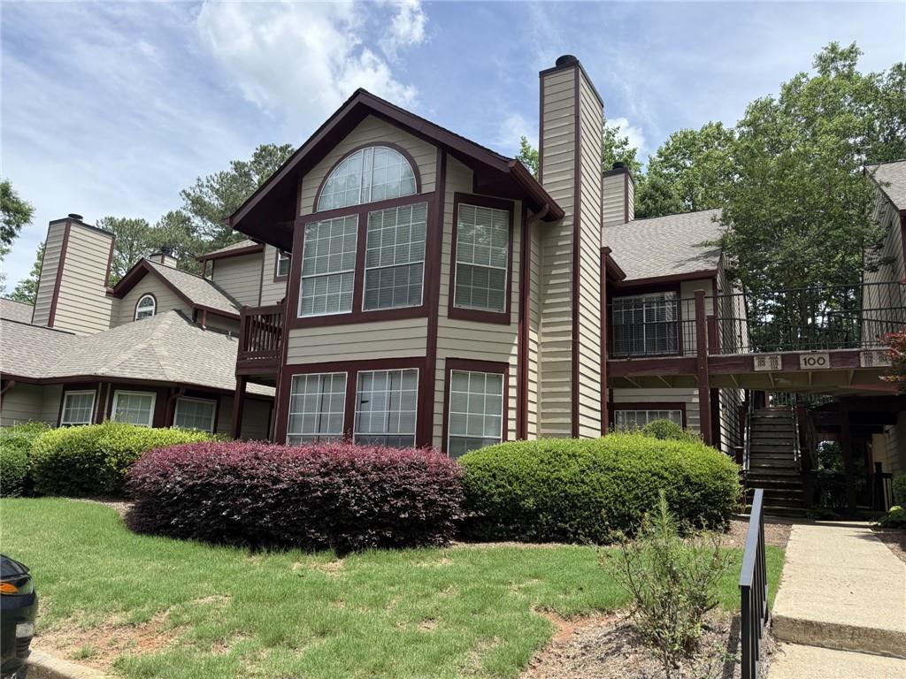 105 Hawkstone Way Alpharetta, GA 30022 - Photo 3 of 23 a front view of a house with a yard