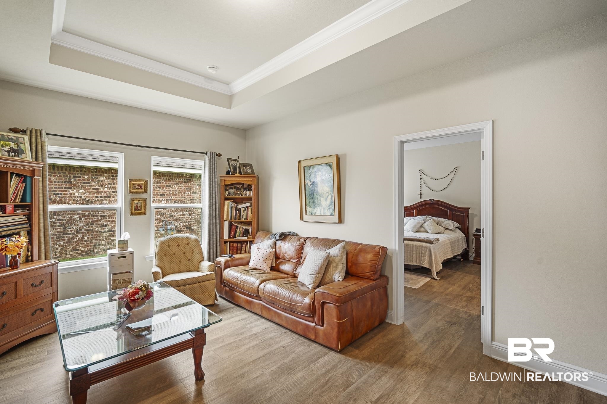 24765 Spectacular Bid Loop Daphne, AL 36526 - Photo 11 of 45 Living room with a raised ceiling, ornamental molding, plenty of natural light, and hardwood / wood-style floors