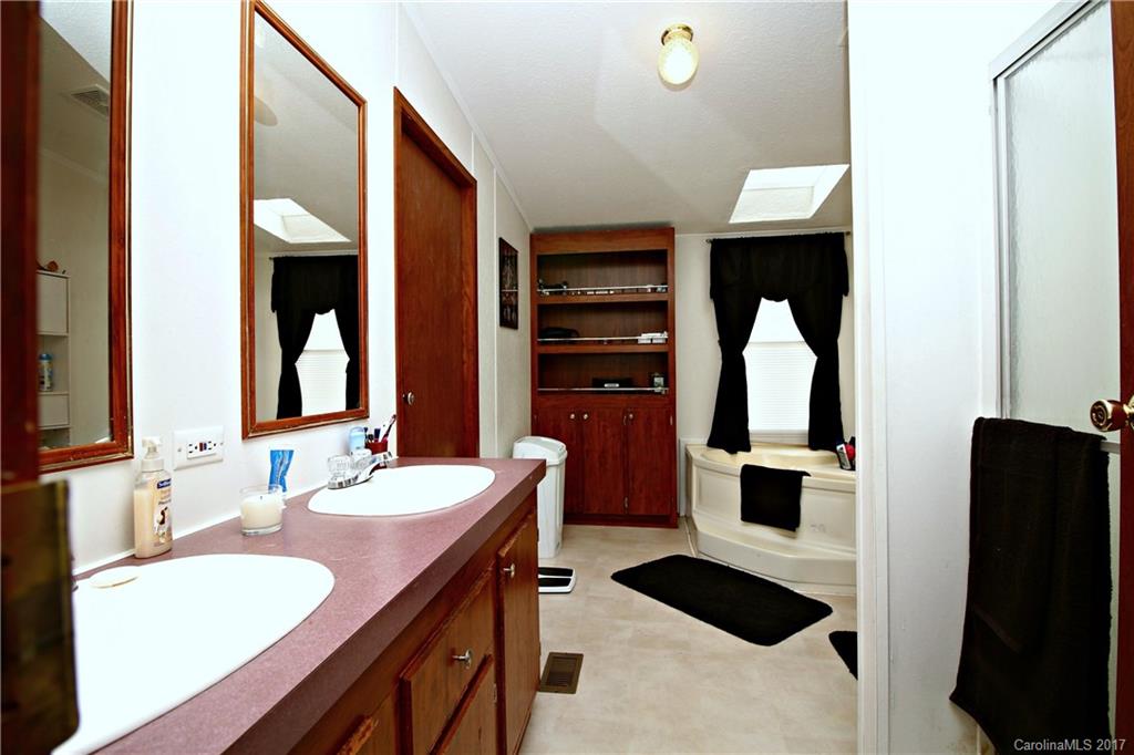 34927 Finger Road Mount Pleasant, NC 28124 - Photo 12 of 19 a bathroom with a sink and a mirror