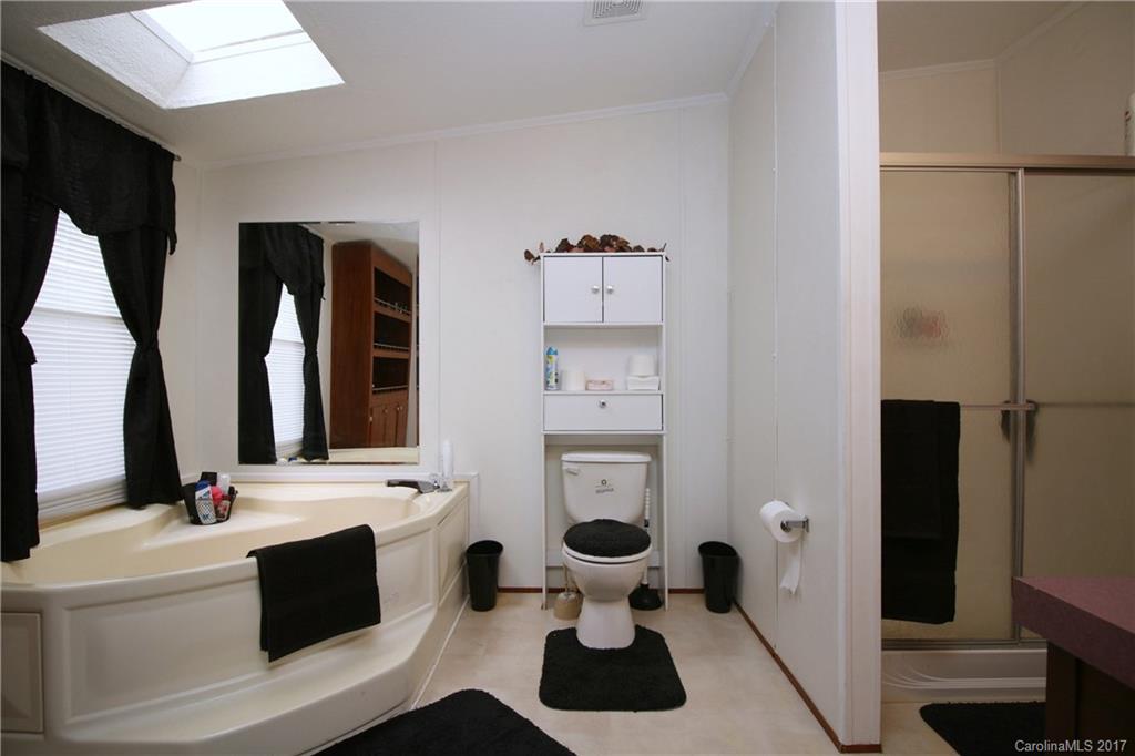 34927 Finger Road Mount Pleasant, NC 28124 - Photo 13 of 19 a bathroom with a sink a toilet and a mirror