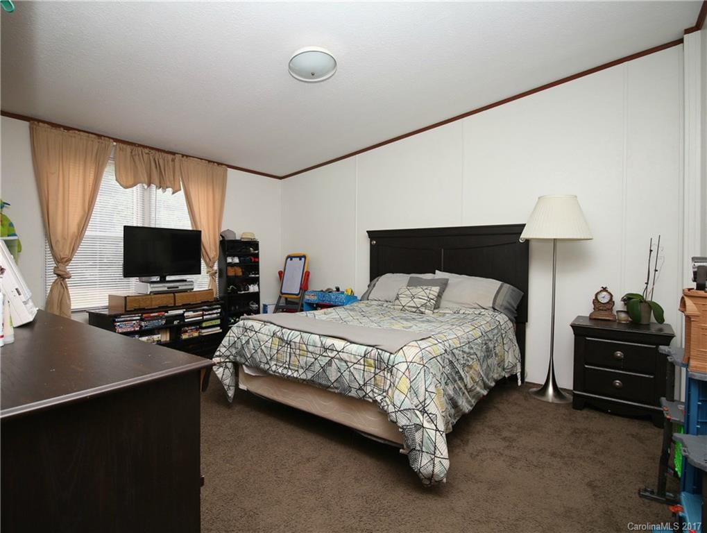 34927 Finger Road Mount Pleasant, NC 28124 - Photo 16 of 19 a bedroom with a bed and a flat tv screen