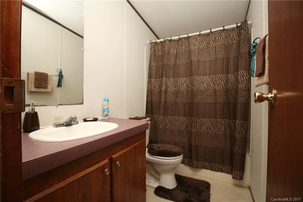 34927 Finger Road Mount Pleasant, NC 28124 - Photo 17 of 19 a bathroom with a sink a toilet and shower