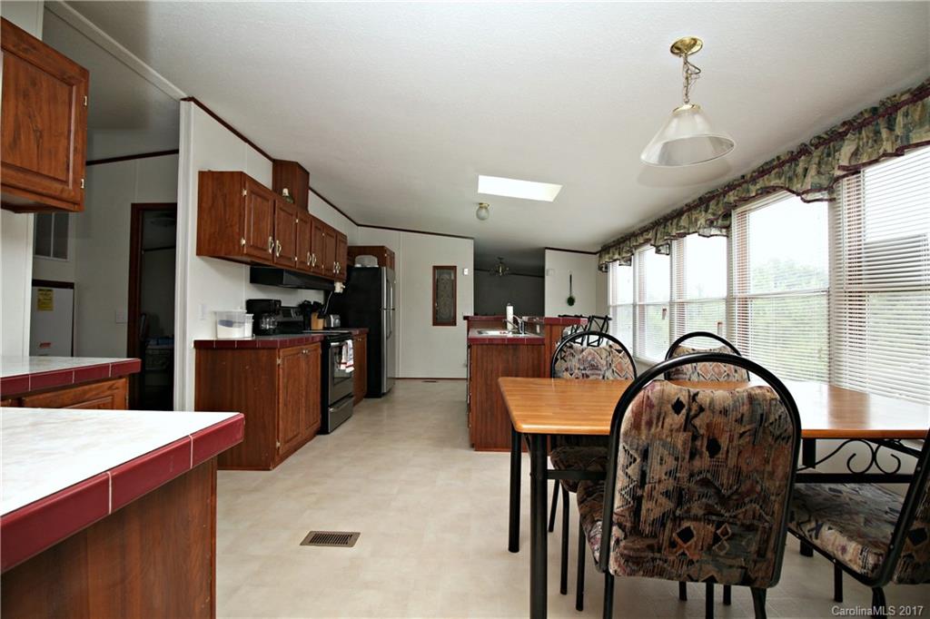 34927 Finger Road Mount Pleasant, NC 28124 - Photo 5 of 19 a kitchen with stainless steel appliances granite countertop a stove a refrigerator and a dining table