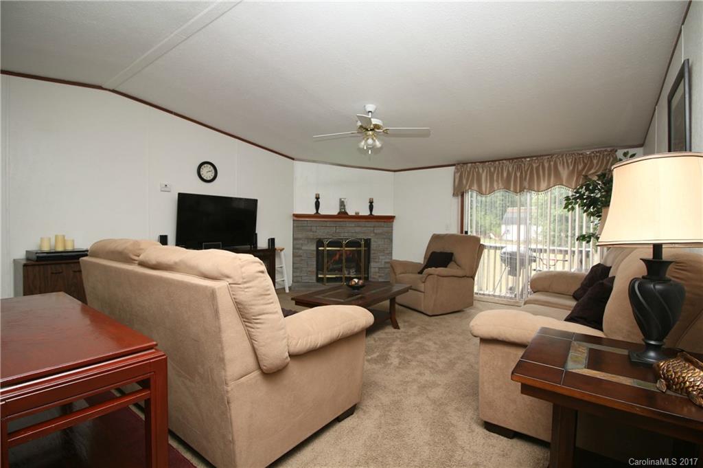 34927 Finger Road Mount Pleasant, NC 28124 - Photo 8 of 19 a living room with furniture a fireplace and a flat screen tv