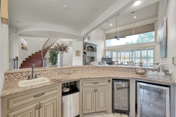 a kitchen with granite countertop a sink and wooden cabinets
