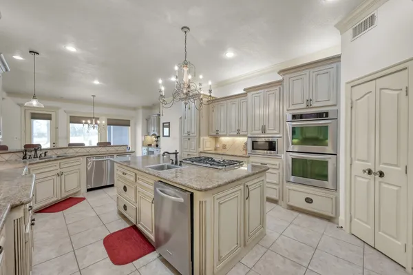 a kitchen with a sink stove and cabinets
