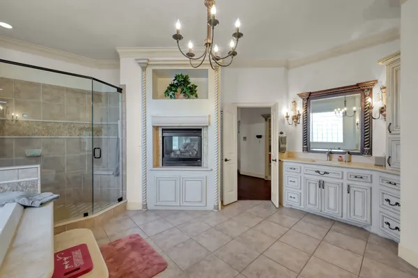 a spacious bathroom with a tub sink shower and mirror