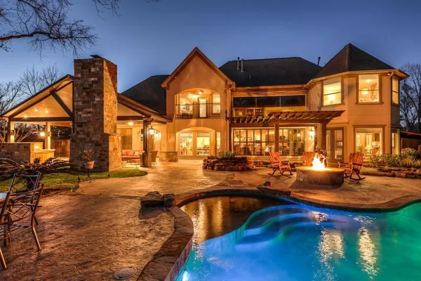 a view of a house with swimming pool and sitting area