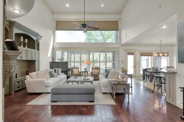 a living room with fireplace furniture and a large window