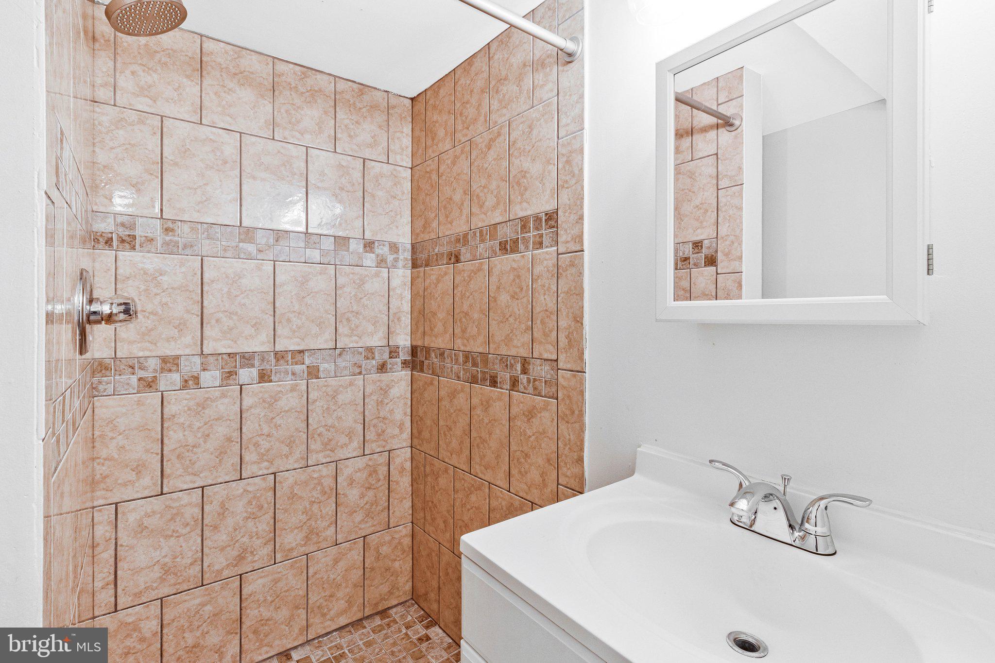 11515 Goodloe Road Silver Spring, MD 20906 - Photo 23 of 33 a bathroom with a sink and a shower