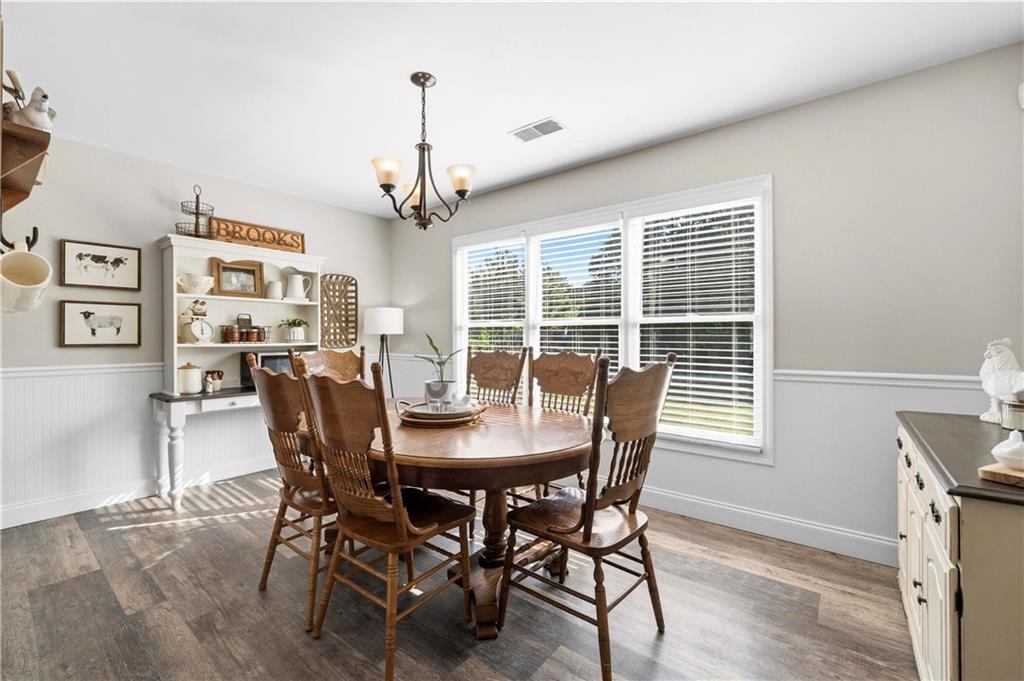 2777 Chickadee Drive Monroe, GA 30655 - Photo 23 of 36 a view of a dining room with furniture window and wooden floor