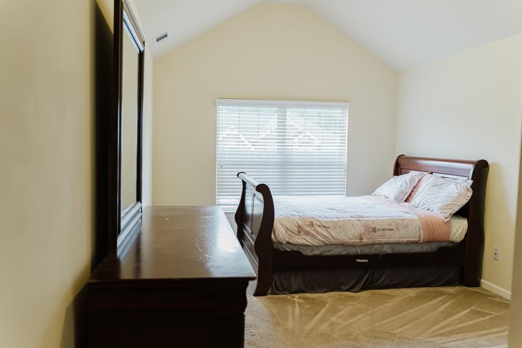 3830 Kittery Point Southwest Snellville, GA 30039 - Photo 15 of 35 a bed sitting in a bedroom next to a window