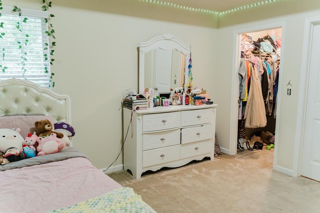3830 Kittery Point Southwest Snellville, GA 30039 - Photo 18 of 35 a bed room with a bed and a closet