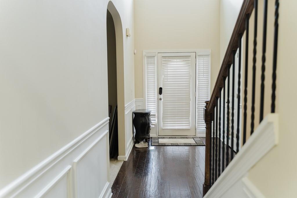 3830 Kittery Point Southwest Snellville, GA 30039 - Photo 2 of 35 a view of a hallway with wooden floor and staircase