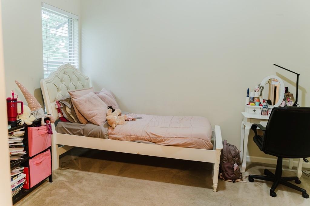 3830 Kittery Point Southwest Snellville, GA 30039 - Photo 21 of 35 a bedroom with a bed and a chair