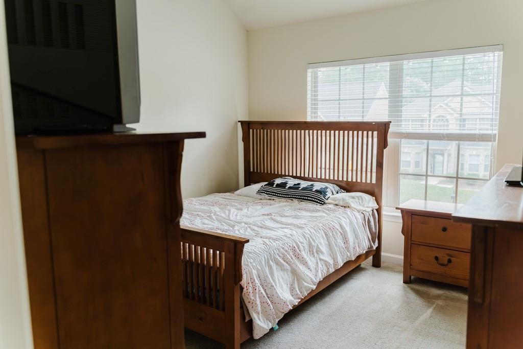 3830 Kittery Point Southwest Snellville, GA 30039 - Photo 22 of 35 a bed sitting in a bedroom next to a window