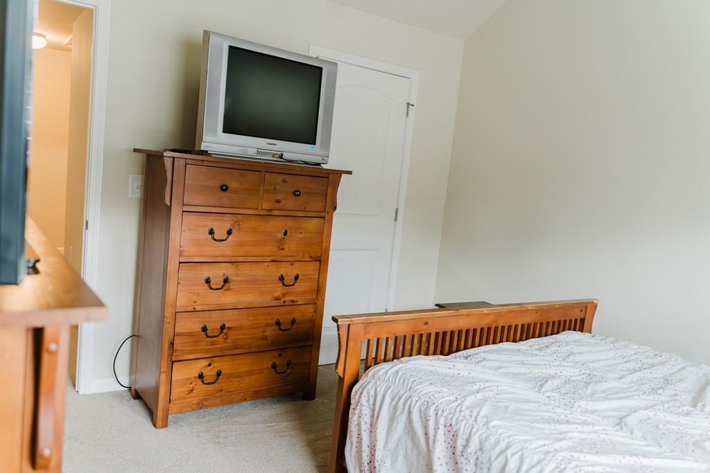 3830 Kittery Point Southwest Snellville, GA 30039 - Photo 23 of 35 a bedroom with a bed and a flat screen tv