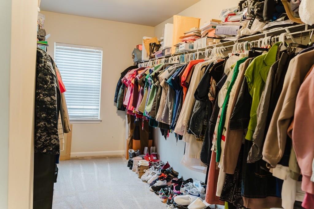 3830 Kittery Point Southwest Snellville, GA 30039 - Photo 26 of 35 a view of walk in closet with clothes and shoes