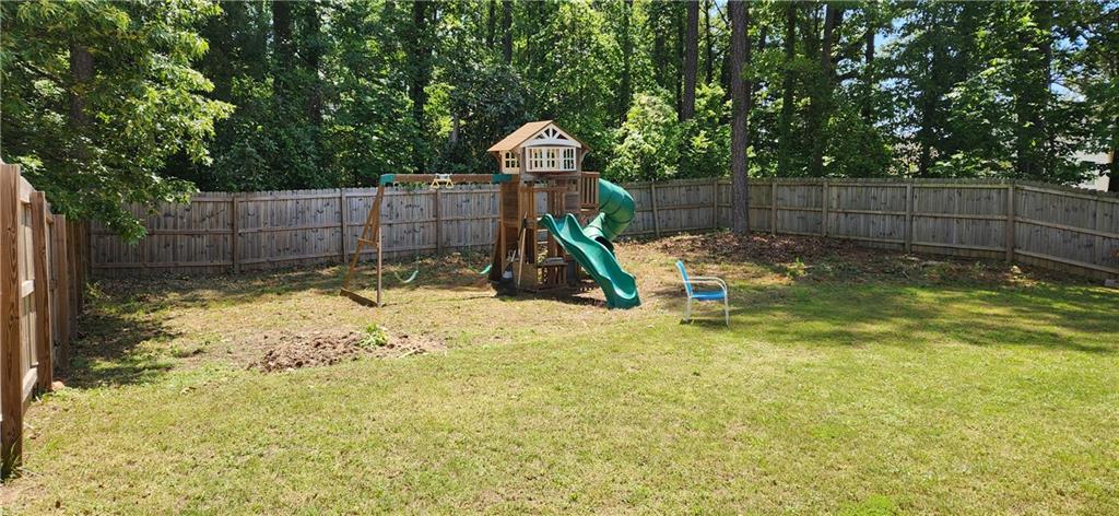 3830 Kittery Point Southwest Snellville, GA 30039 - Photo 34 of 35 a view of a yard with a slide and a tree