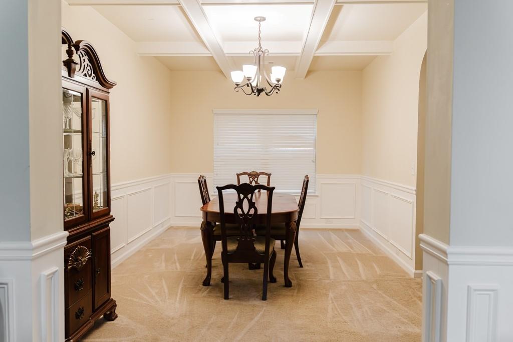 3830 Kittery Point Southwest Snellville, GA 30039 - Photo 5 of 35 a view of a dining room with furniture and a chandelier