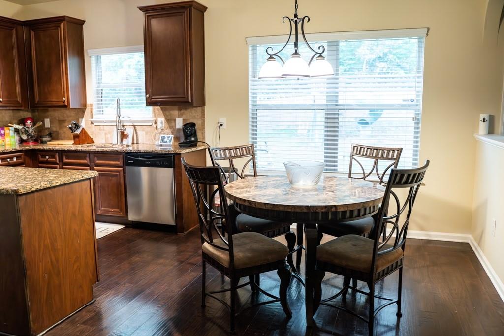 3830 Kittery Point Southwest Snellville, GA 30039 - Photo 9 of 35 a view of a dining room with furniture and wooden floor