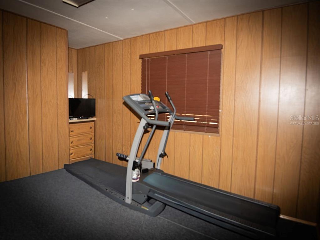 240 Kitty Avenue Interlachen, FL 32148 - Photo 13 of 44 a room with gym equipment and windows