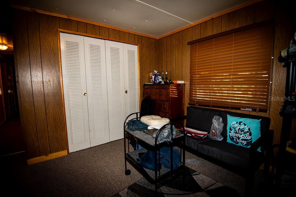 240 Kitty Avenue Interlachen, FL 32148 - Photo 17 of 44 a room with furniture and wooden walls