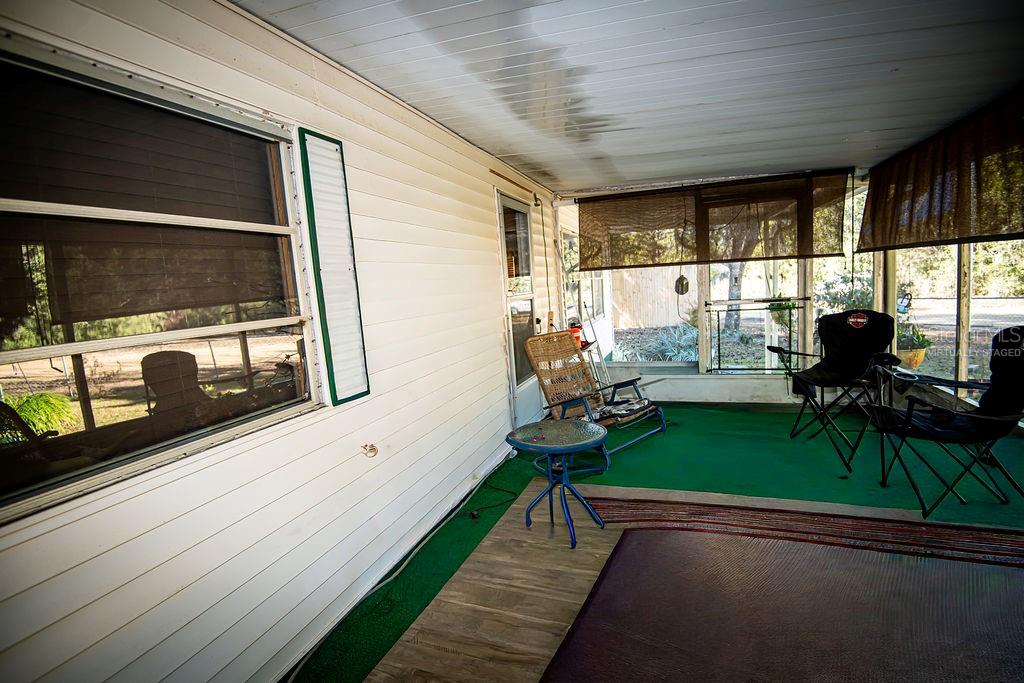 240 Kitty Avenue Interlachen, FL 32148 - Photo 24 of 44 a view of a porch with furniture and a yard
