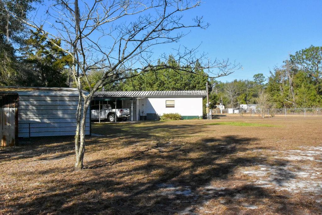 240 Kitty Avenue Interlachen, FL 32148 - Photo 36 of 44 a front view of a house with a yard